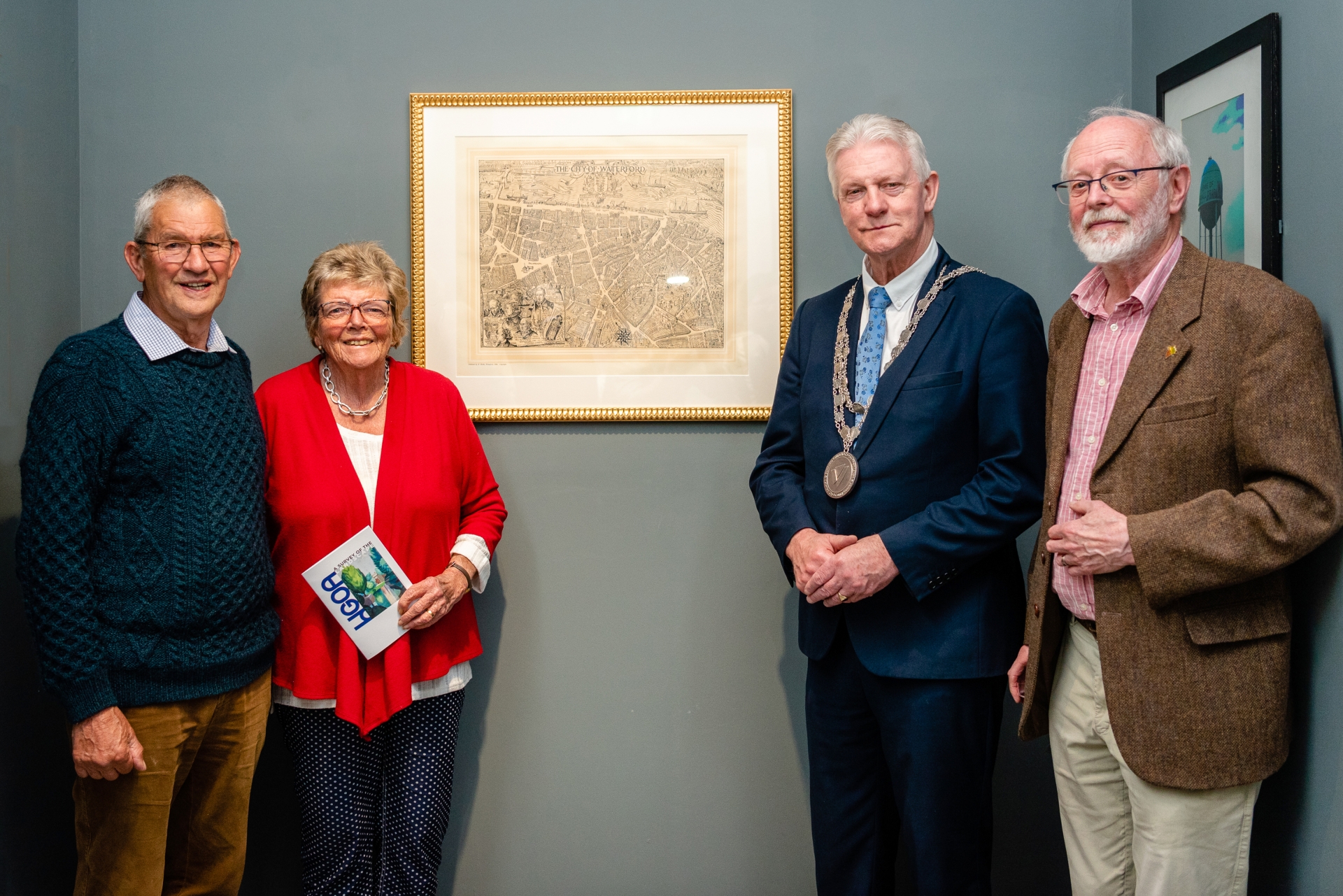 Accompanied by song and a dance, Thursday May 18th saw the official opening of the ‘A Survey of the Landscape’ exhibition at the Waterford Gallery of Art by Mayor of Waterford City and County, Cllr John O’Leary. In his speech, the Mayor gave an impassioned speech for arts in the county and honoured those that have recently donated artworks to the Waterford Art Collection. Photography by David Murphy Read more of this story below > Roger and Joan Johnson with Mayor O'Leary and Dr Peter Jordan Photography by David Murphy Mayor O’Leary noted, “Artworks such as these show how important Waterford is as a centre for the arts and creativity both historically, though perhaps more importantly, in the present moment. “There is no surprise that an exhibition of landscapes featuring Waterford and Ireland should generate such interest. This is a county, an indeed a country, that in many ways is identified and beloved due to its magnificent landscape and scenery.”  Present on the evening was Dr Abdul Bulbulia who, as Council Member of the Friends of the National Collections of Ireland, recently assisted in the donation of the painting ‘The Coulin’ by Robert Burke (1949).  Edwina Foyle and Martina O’Byrne of Artform Dunmore East were thanked for the donation of artwork ‘Parchment Tree 5’ (2018) by Michael Wann. There was also a special thanks for Joan and Roger Johnson who presented to the gallery a fascinating map of Waterford City from 1948, also created by artist Robert Burke. Performing on the night were ‘broken-folk’ duo Lunatraktors who have recently relocated to Stradbally.  Dressed in larger-than-life jester like costumes made from reclaimed hazard tape they performed a series of land-themed protest songs and dances whilst processioning around the building. Music was also provided courtesy of Harry O’Neill of Waterford’s Luca record and skate shop, who was resident DJ for the evening. Also present on the night were Cllr. Joe Conway and Cllr. Eammon Quinlan, Dr Peter