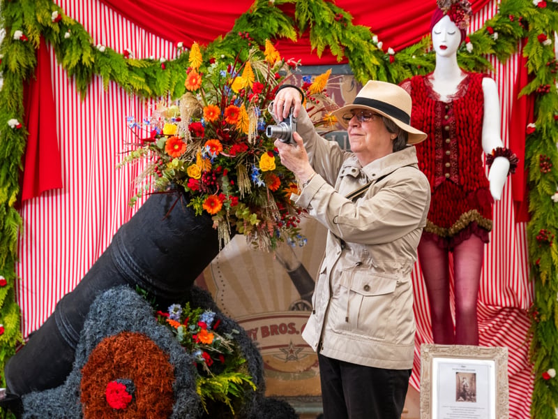 Barbara Hampel, a a first time visitor to the show photographing a floral display designed by students at Leeds City College. 