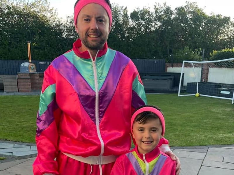 Father an son dressed in pink.