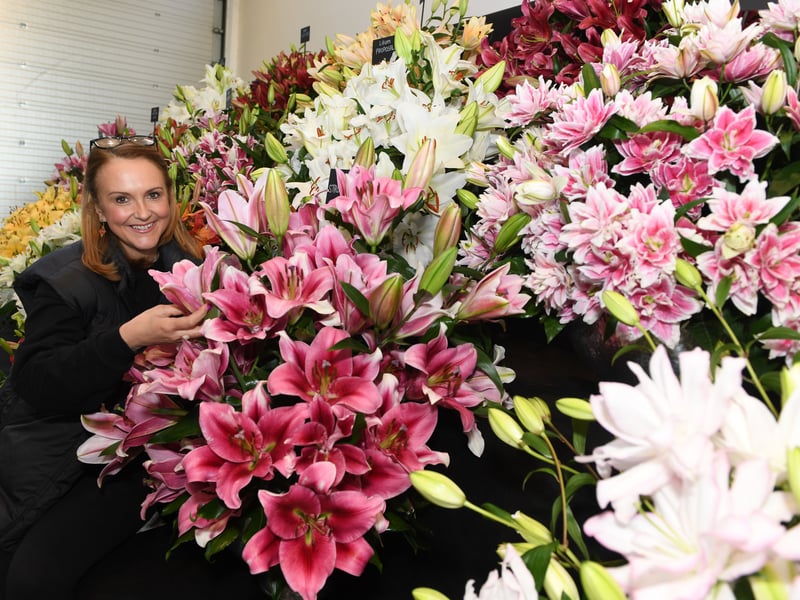 Gemma Miller amongst the lilies by Harts Nursery , who won a Premier Gold Award in the Grand Floral Hall.