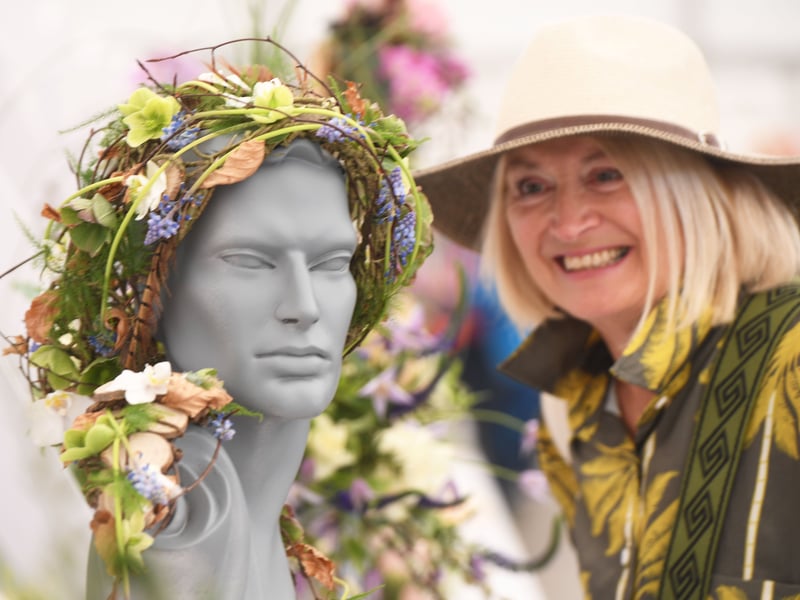 Visitors view the exhibits in the Floral Art Pavilion.