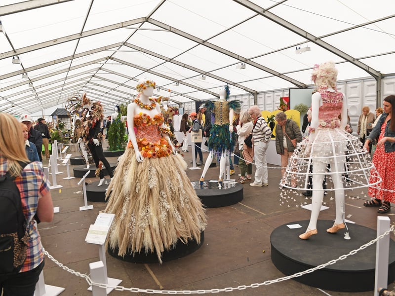 Visitors view the exhibits in the Floral Art Pavilion.