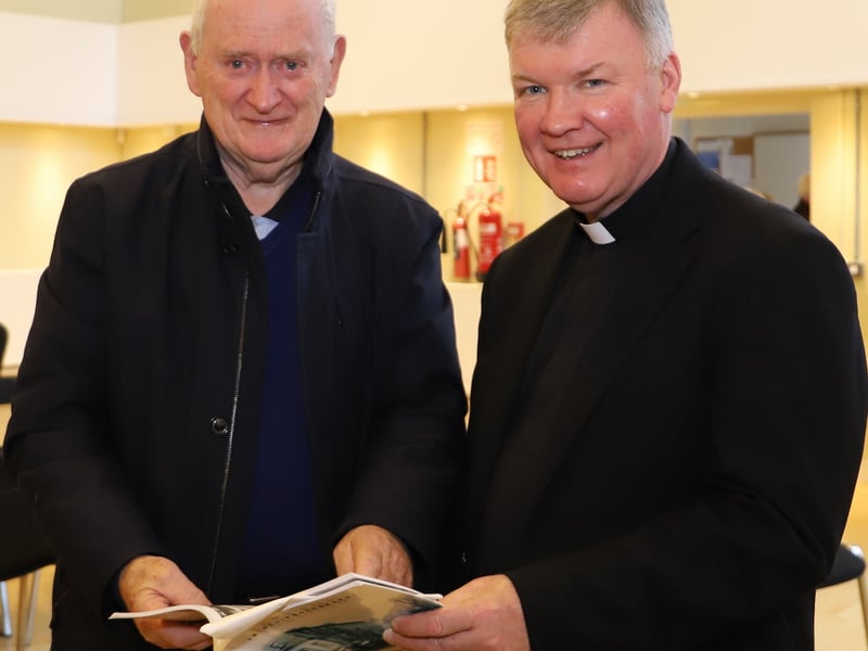 Frank Shovlin showing Fr Niall some photographs from the Donegal Book.