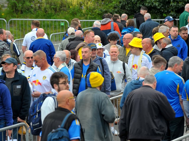Fans queue for  Leeds United official coaches.