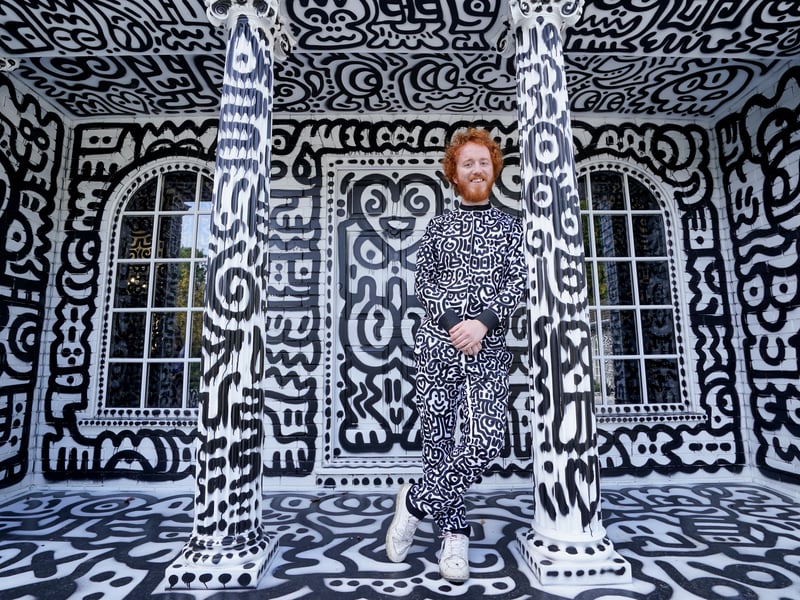 Mr Cox was keen to blend in with his surroundings during a photo shoot with his wife Alena.