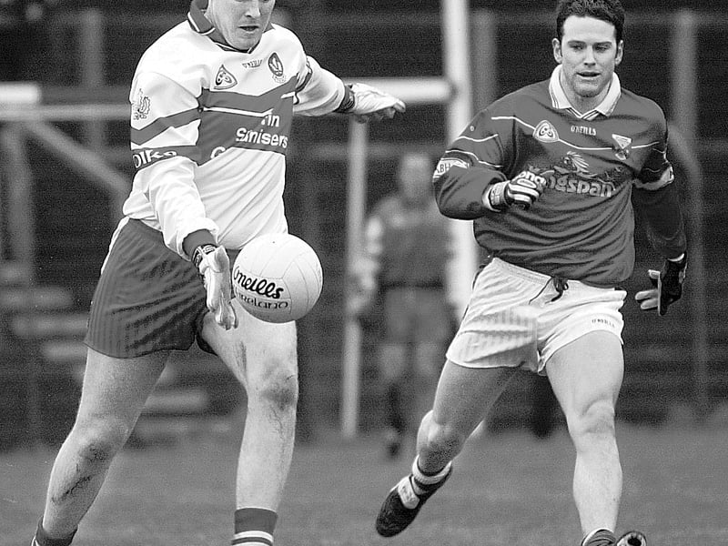 Dermot Heaney clears his lines as a Cavan player closes in at Celtic Park in a Senior National League match.