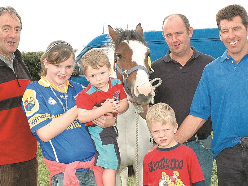 Caption: Paul Moffatt, Gowna with Aisling, Darragh, Oisin and John O'Toole and Joseph Murtagh from Colmcille