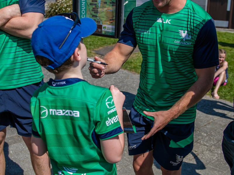 There was huge excitement at the quays in Carrick on Shannon last Saturday afternoon as a large contingent of the Connacht Rugby team and management along with some special guest riders had a stopover at Moon River on their Galway to Sligo Fundraising Cycle #care4claire. For approximately an hour, the cyclists and their support team and met with many of the local young players and signed autographs and jerseys before setting off on the road to Sligo where they finished their 218k trip across the five counties of the province later that evening. Varadkar says IRFU should listen to trans players ‘excluded’ from contact rugby Amongst the large group of cyclists and travelling players were Connacht Head Coach Andy Friend, Ireland playing legends Kieran Marmion and Eric Elwood and former Mayo, Roscommon and Offaly GAA manager John Maughan. The cycle began at The Sportsground in Galway in the early hours of Saturday morning and finished at Sligo RFC. The route took in all five counties with stops in Ballinrobe Co. Mayo, Ballyhaunis Co. Mayo, Frenchpark Co. Roscommon, Carrick-on-Shannon Co. Leitrim, and finally Ross and Claire’s home in Coolaney Co. Sligo, before the final stretch to Sligo RFC. The fundraiser was for 35-year old Sligo native Claire Carpenter who suffered a serious and life-changing event earlier this year. Claire suffered a stroke at her home in Coolaney. 'We don't stand still' on issues of player welfare, World Rugby vows After being rushed to the ICU unit of Beaumont Hospital she was placed in an induced coma for over a week following a life-saving operation. Claire is now thankfully on the road to recovery, however significant funds need to be raised to allow her to continue her rehabilitation in Dun Laoghaire, and eventually lead an independent life at home. Claire’s partner Ross Mannion is a Rugby Participation Officer with Connacht Rugby and was Head Coach of the Connacht Women’s team in 2021. They have three children, Luke (14), Anna (10) and Zach (7).