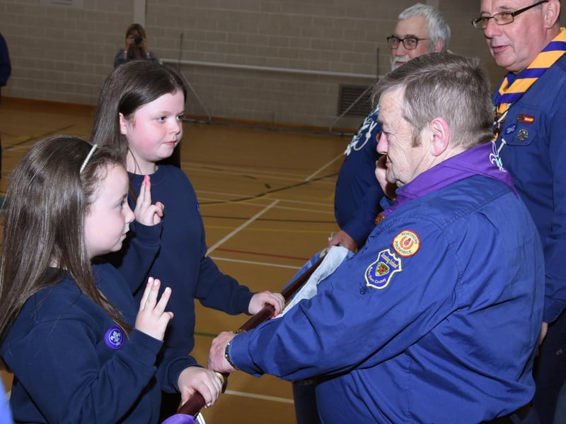 Caitlyn and Cara make their Scout Promise.