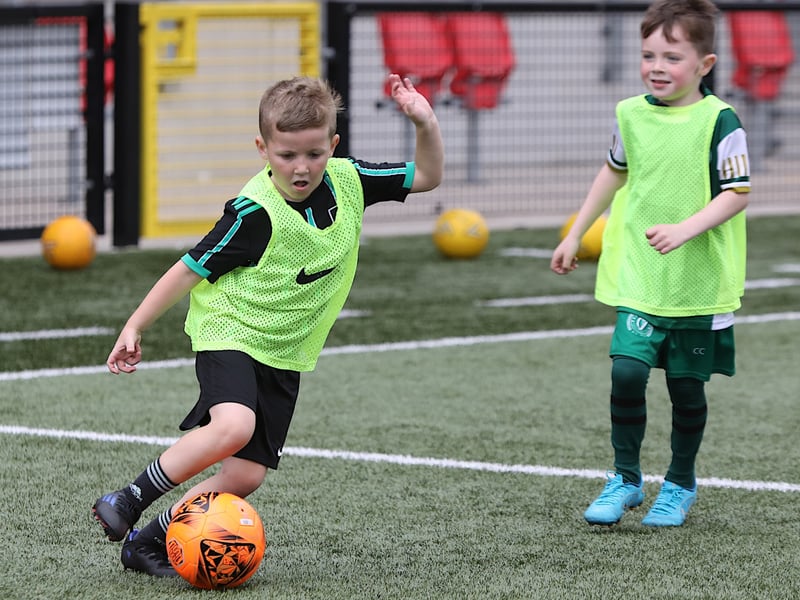This young boy shows his skills on the ball.