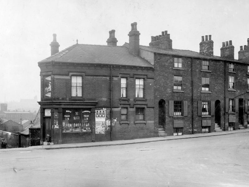 On left junction with Buslingthorpe Lane. Sweet shop, advertisement for Hudsons' soap over door. Row of four storey houses, with recessed doorways. Large factory building with square tower is the Co-Operative Wholesale Society (CWS) shoe factory which was on Education Road. Pictured in April 1930.