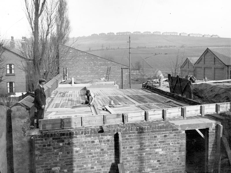 Construction of air raid shelter on site of Meanwood Road Destructor. Workman or gaffer stands in one corner. A row of houses on Potternewton Crescent can be seen on the hilltop at the rear of the photo from November 1938.