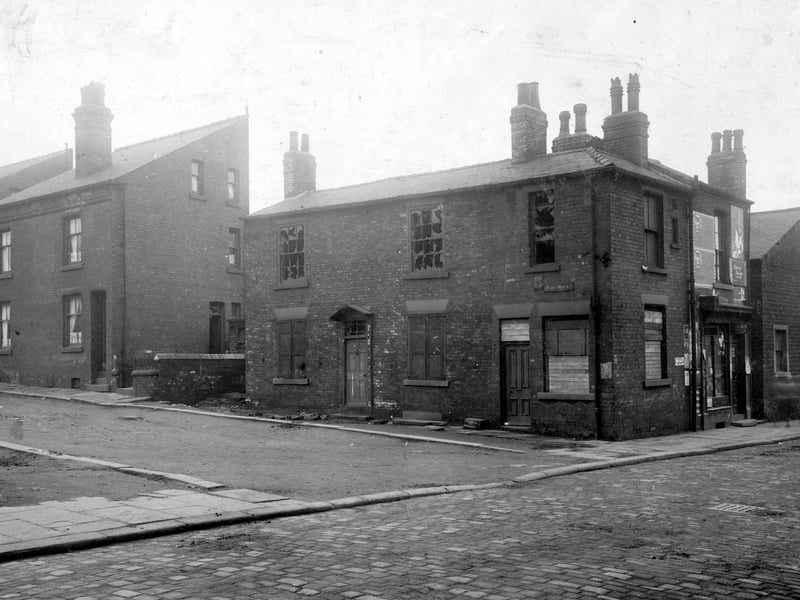 Raby Mount from Sheepscar Street in April 1930. To the left waste ground where one side of Raby Mount has been demolished. The shop towards the right is on Sheepscar Street.