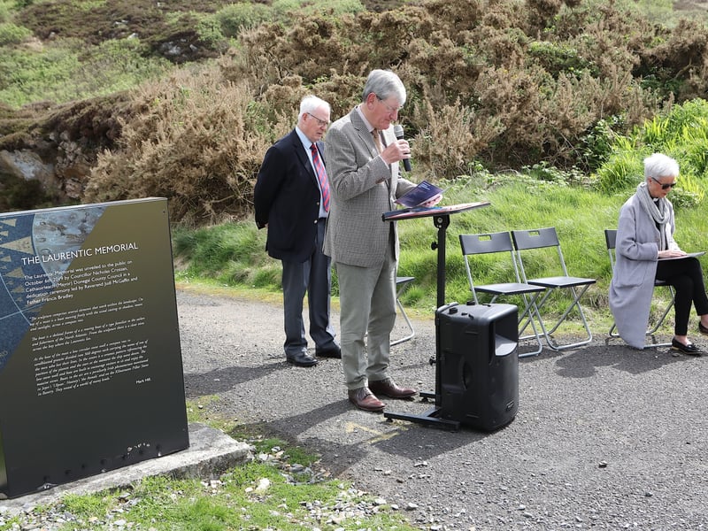 Colonel Brian O'Reilly reading the Irish Roll of Honour. Seated is Canon Judi McGaffin.