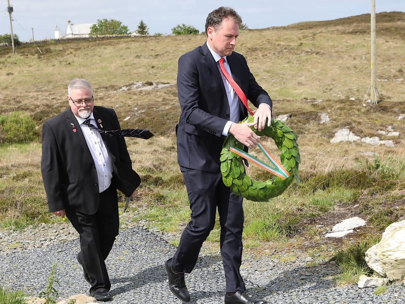 Minister for Agriculture, Food and the Marine Charlie McConalogue preparing to lay a laurel wreath at the Lauarentic Commemoration.