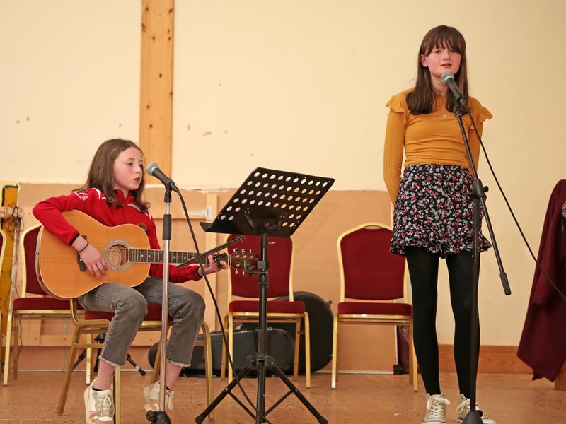 Caption: Annie and Norah Drake performing at the celebration
