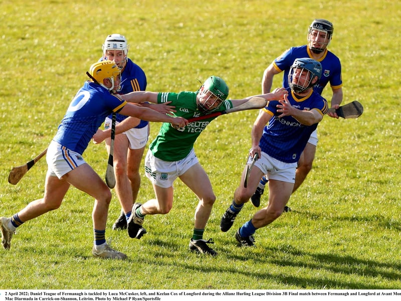 Caption: Daniel Teague of Fermanagh is tackled by Johnny Casey, left, and Keelan Cox of Longford during the Allianz Hurling League Division 3B Final Photo by Michael P Ryan/Sportsfile