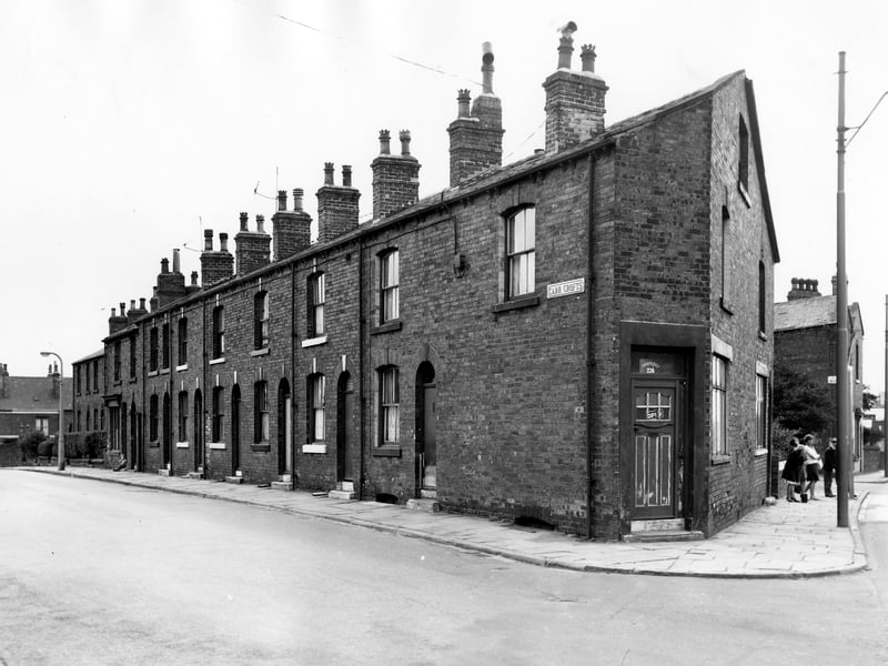 On the left of this photo from September 1966 is a row of back-to-back terraced houses on Carr Crofts. At the corner on the right is number 236 Tong Road, a chiropody practise. On the far right people queue at the bus stop.
