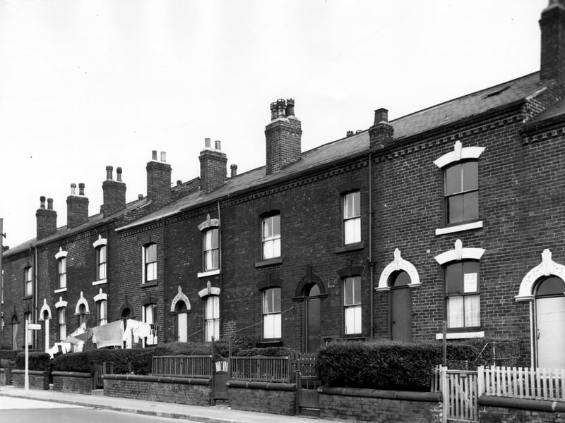 Tong Road in September 1966, numbers run from the left in descending order to number 212 on the right with the doorway of number 210 on the right edge. The majority of these houses went through to Cardwell Street apart from number 214 which was a blind back, the resulting gap in the terrace was occupied by an outside toilet block. Included in slum clearance plans for Armley.