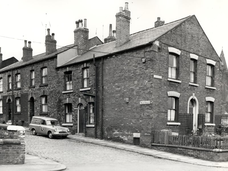 Main Street runs from the left edge of this view, numbers 8, which is just visible, to 2. Numbers 8 to 6 are back-to-backs whereas numbers 4 and 2 went through to numbers 5 and 3 Parsonage View. A van belonging to Hope's Heating and Engineering Ltd stands outside number 2. On the right is number 200 Tong Road which was called Hope Cottage. Pictured in August 1966.