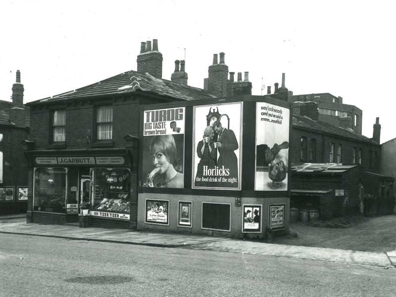 Town Street in September 1966. On the left edge of this view the entrance to Station Road is visible. A shop run by J. Garbutt follows to the right. Scholefield's Fold is visible on the right edge.