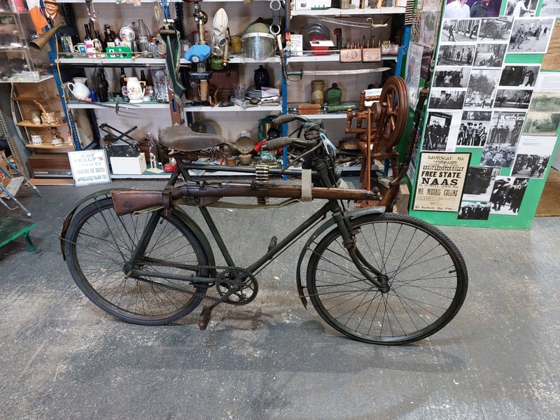 An early 20th Century British Army bike and Lee-Enfield rifle
