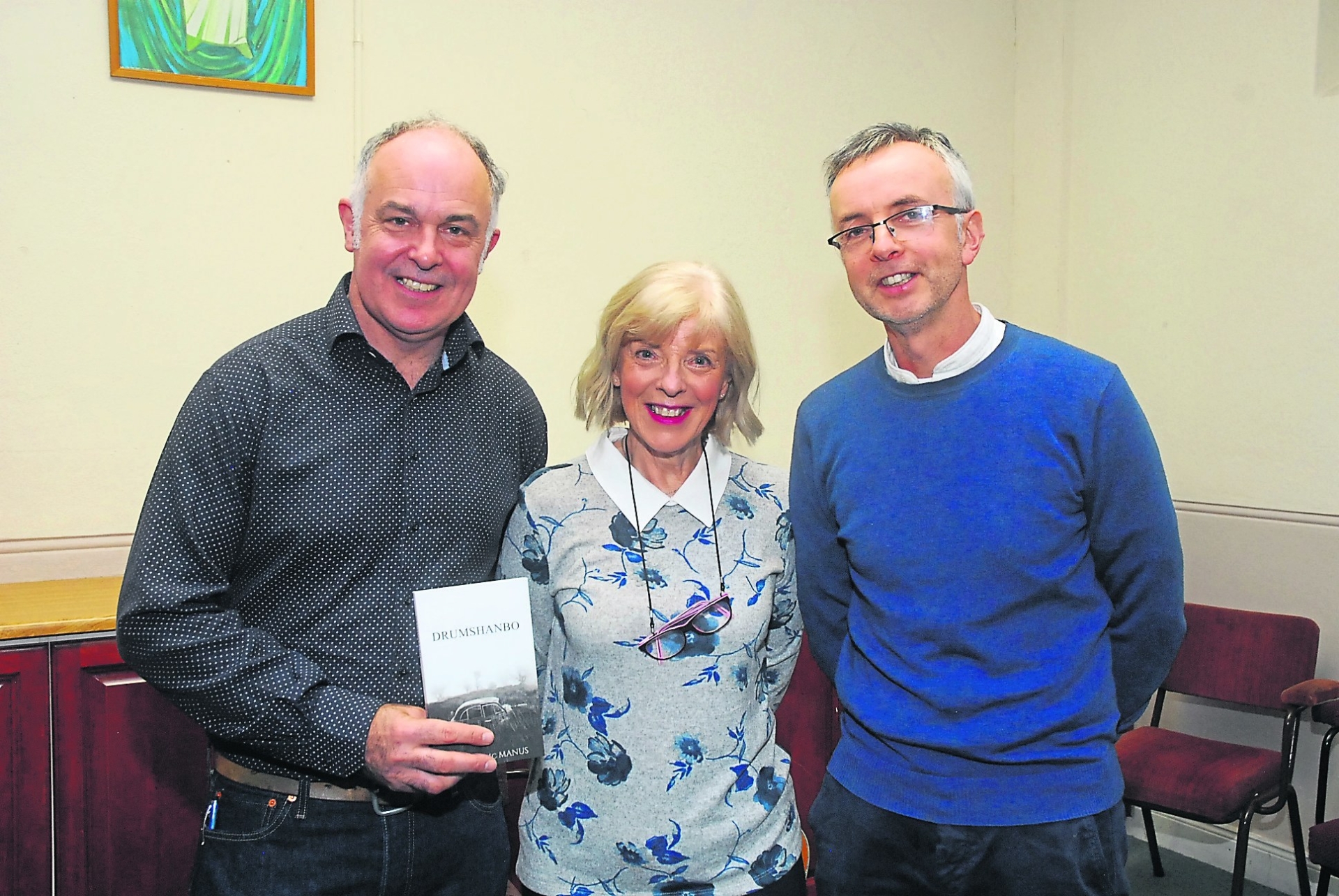 Use > to navigate photos   Cousins: Conor, Maria and Shane McManus A large crowd turned out for the launch of Conor McManus' Drumshanbo book at the weekend in Aras Phadraig.This collection of 25 short stories and vignettes is narrated in a young boy's voice. The stories comprise a naturalistic depiction of life in Drumshanbo in the late 1970 and early 1980s.These stories will be enjoyed by anyone who has experienced life in an Irish town, but more so they will be cherished by those who have lived in, visited or know anyone from Drumshanbo. Mc Manus captures a bit of everything, snapshots of a life lived in a lively town full of characters.There is drink and drunks, stories of shooting pike and stuffing turkeys, cures for warts and playing bingo, tales of work, miners, deliveries and haircuts and everything else that Conor could recall!Conor begins his collection by telling us he knew “every nook and cranny, every twist and turn, every dip and hallow” of Drumshanbo. He regails stories from a time when the town had 13 pubs, some that also acted as grocery stores and tailors and drapery shops.The stories are funny, they are reminiscent of another era but they are written in such a way that you feel like you are hearing them first hand at the foot of the bar.Conor recalls visiting friends and family with the Captain and says “Christmas was worse, he had to call into every house that ever had a light on, as my mother would say and there was always tea and cake and a quick one to help him stay between the ditches.” This is a wonderful book full of beautiful descriptions of Drumshanbo, its buildings, its geography and its amusing people.It is a book to have on your shelf and pull put and read aloud to get a good laugh and certainly a talking point amongst several generations. It certainly won't be the last book by Conor McManus who seems to have a treasure trove of stories from the town. The book is available in local book shops.