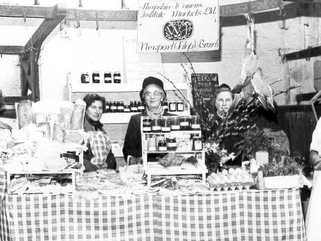 A nostalgic look back to Newport in 1961, when the Women’s Institute ran a market stall in the town’s Indoor Market. Now known as Newport Country Market, the stall has since marked over 50 years in the community. Seen here from left are Mrs Lea (assistant controller), Mrs Williamson (secretary), Mrs Miller (controller), Mrs Rugman (treasurer) and Mrs Vallings (committee member), proudly representing the Newport WI. The stall carried the sign “Shropshire Women’s Institute Markets Ltd”, reflecting a long-standing tradition of local produce and community enterprise.