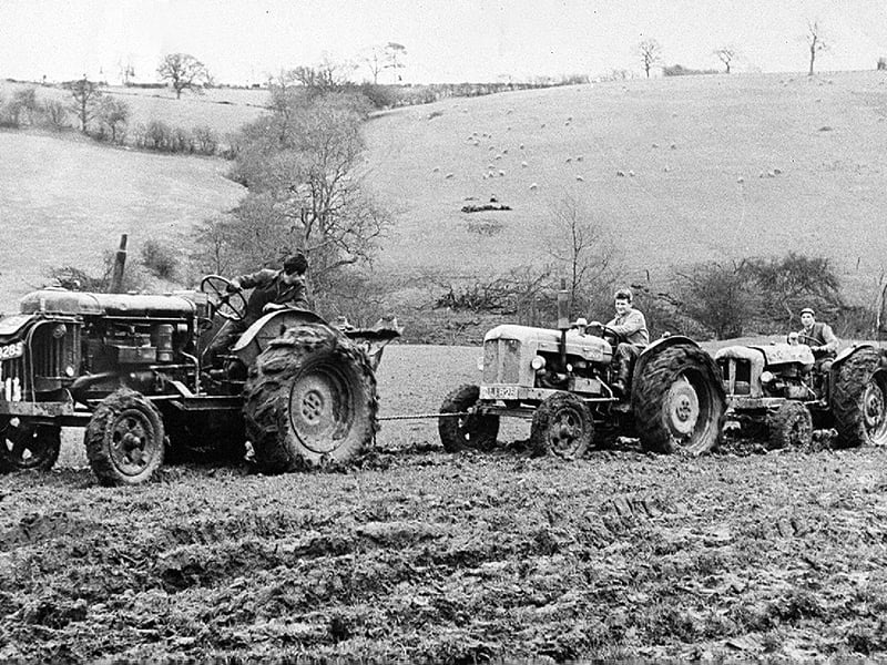 February 1961 at Lower Faintree Farm near Bridgnorth, where a tractor had overturned in a dingle, trapping Miss Helen Marsh. She was rescued by Mr Eric Preece (right), while efforts were later made to recover the machine. This image shows the recovery attempt a few days afterwards, with another tractor, ridden by Tom Benson, joined in the effort (centre), as it proved unable to pull the vehicle free on its own.