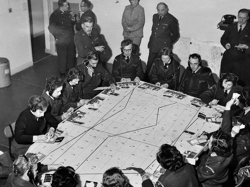 November 13, 1961, inside the new headquarters of the Royal Observer Corps in Shrewsbury. The image captures a scene of quiet concentration at what was described as the nerve centre of the West Midlands Nuclear Warning and Monitoring Organisation. Members shown are part of the 600-strong Number 16 Group of the Royal Observer Corps, an organisation once referred to as the “trigger” of the RAF V bomber force and the nation’s “fall-out eyes” in the event of nuclear war.
