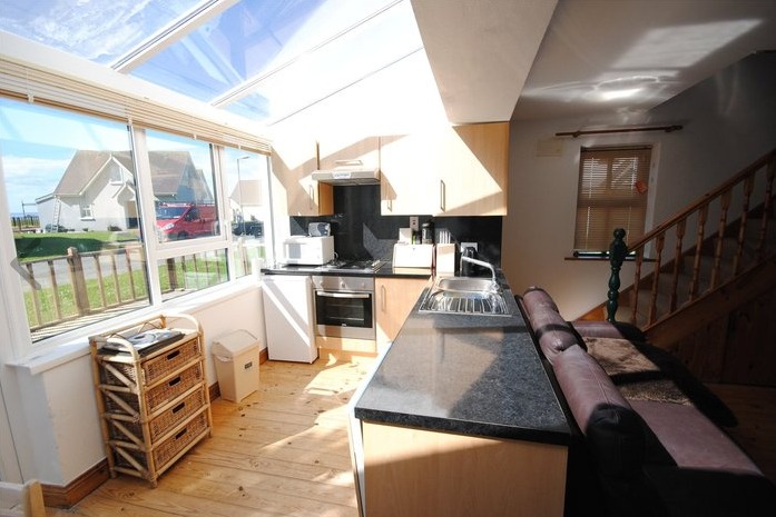 The property has an open plan living area which comes with the addition of a glass roof over the kitchen for an abundance of natural light.