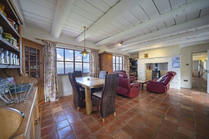 The house has been built to very high standards both inside and outside. On a total living area of c. 90 sqm the house offers a large open plan living, dining and kitchen area. There is a fully fitted, wooden kitchen and a wood burning stove and stunning views from both the living and the dining area. In addition there is another living room which could also be used as a study or an additional bedroom.