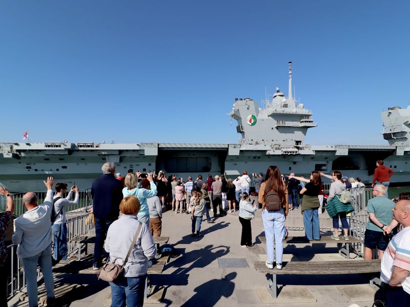  HMS Queen Elizabeth looks glorious as she returns to Portsmouth after major revamp on Monday 27th April 2026

Pictured: People at the Round Tower watching as she comes in 

Picture: Habibur Rahman