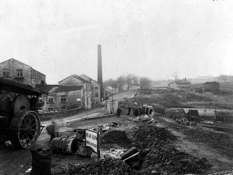 A view of bridge repairs on Roker Lane in November 1939 showing workmen and equipment including part view of a traction engine. On the left is a factory building with a tall chimney.