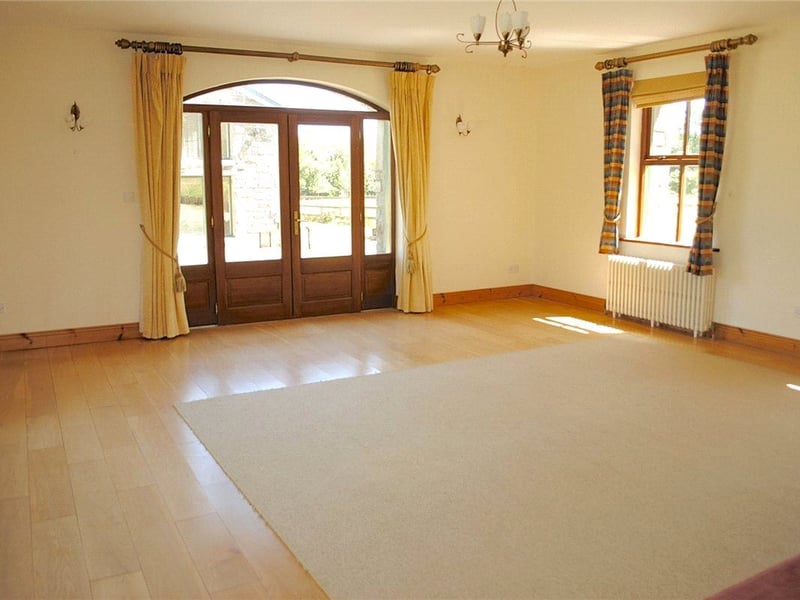 The living room is magnificent with solid oak flooring and a fitted stove with the original station house stone surround. This room is spacious and very bright with an abundance of windows, a dining area and glass doors that lead to the patio and garden.