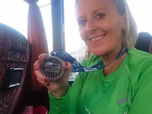[caption id="attachment_125931" align="alignnone" width="527"] A runner shows off her medal from the Dublin City Marathon[/caption]