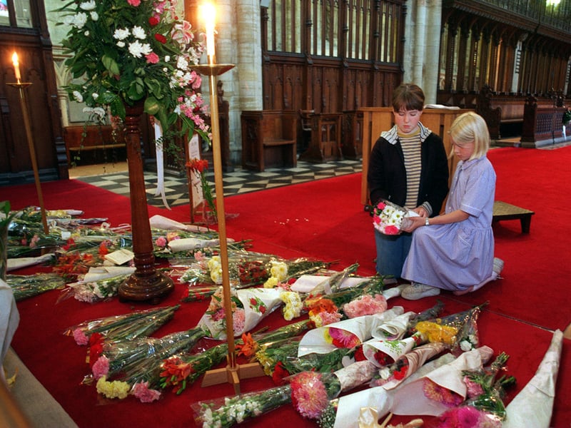 September 1997 and two young choristers from Selby Abbey, Mary Hindmarsh, left, and Sara Ross, read some of the many messages of sympathy left in the memory of Diana, Princess of Wales.
