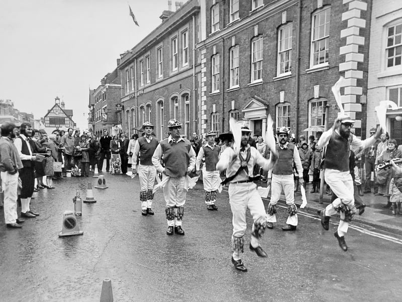 South Shropshire Morris Dancers pictured in 1979. The caption on the back of this print reads: 'The South Shropshire Morris Dancers, who gave displays throughout the district on Saturday, brave the showers at Northgate, Bridgnorth.'