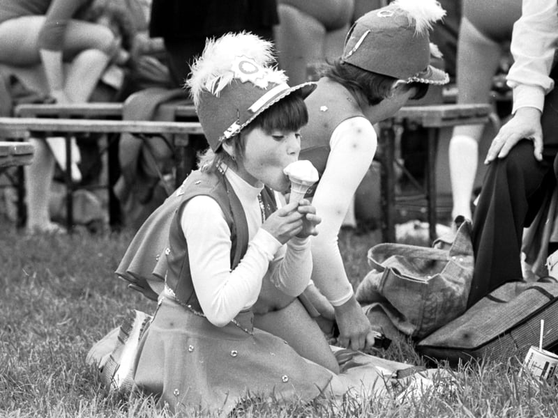 A young majorette enjoys an ice cream at Holyrood Park, Edinburgh, on the Miners Gala Day in 1979