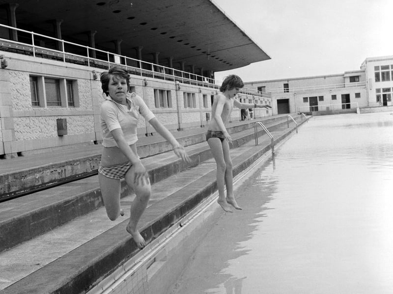 Rhona Heeps and Stewart Somerville are the first children in Portobello open-air pool as it re-opens in June 1976