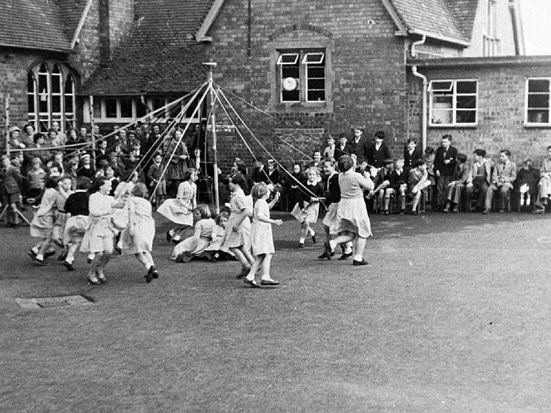 Maypole dancing at High Ercall Primary School, around the mid-1950s. Mrs Janet Owen, née Nicholls, is pictured second from the left—just to the left of the dancer in the dark top with her back to the camera.