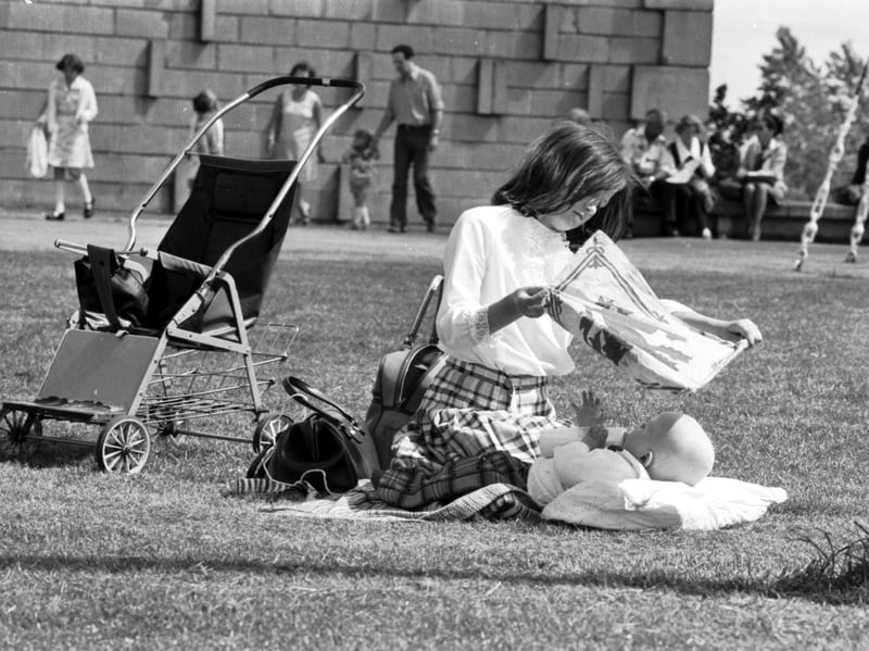 A little girl uses the Scottish flag/ensign to shade baby from the sun at the SNP rally at Bannockburn in June 1977