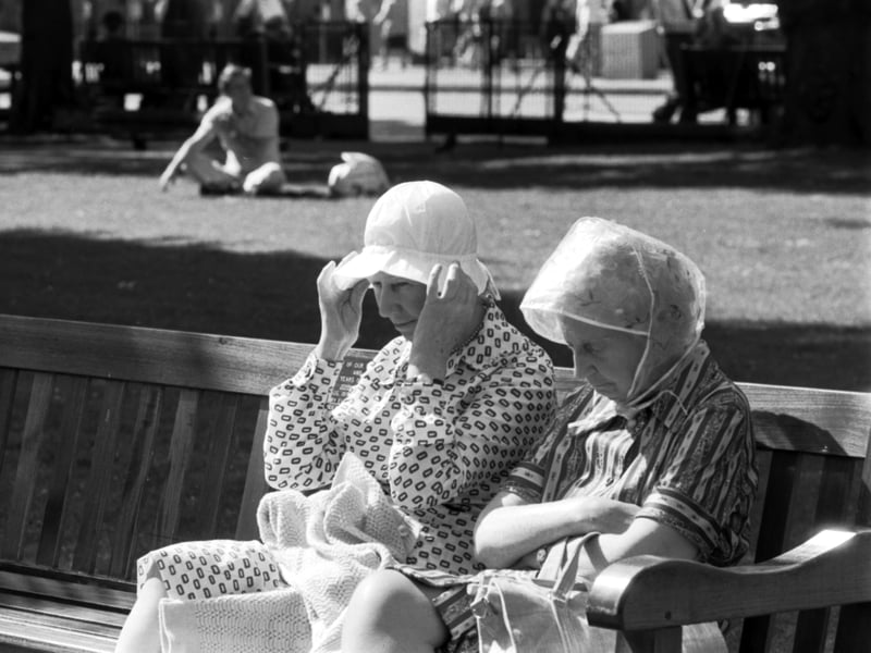 Summer in Princes Street Gardens in June 1979 - two Edinburgh ladies in the summer sunshine wearing rain hats... just in case