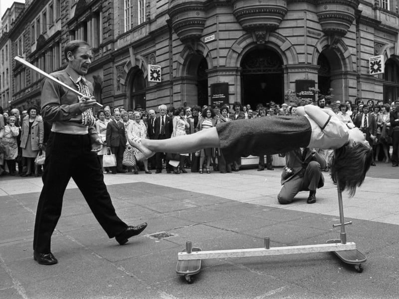 John Baird, of the Scottish Conjuring Association, and his assistant Evelyn Rose perform their sword-balancing trick for the crowds in Buchanan Street, Glasgow, in June 1976