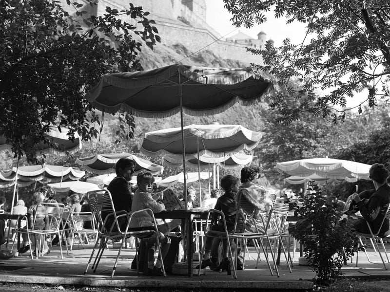 People enjoying the summer sunshine at The Piazza open-air cafe in Princes Street Gardens, Edinburgh, in August 1970