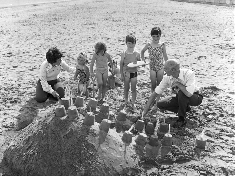 Children building a sandcastle on Portobello beach in the summer of 1975