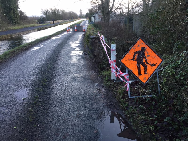 The narrow roadway over the damaged bridge.