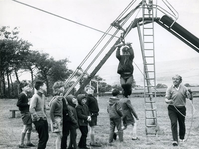 Mr Riley helps children on the zip wire at Halifax Children's Holiday Home in around 1971