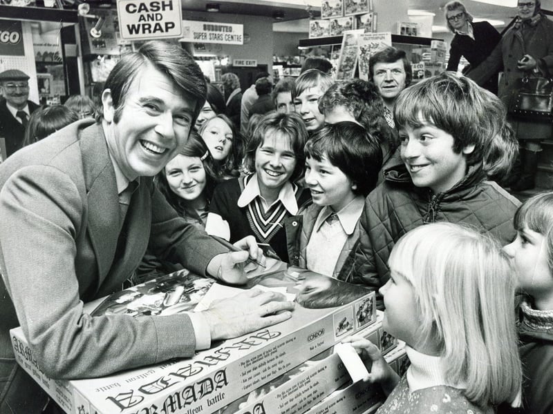 Children's TV star Leslie Crowther draws a crowd to Redgates toy shop, Sheffield, in November 1975