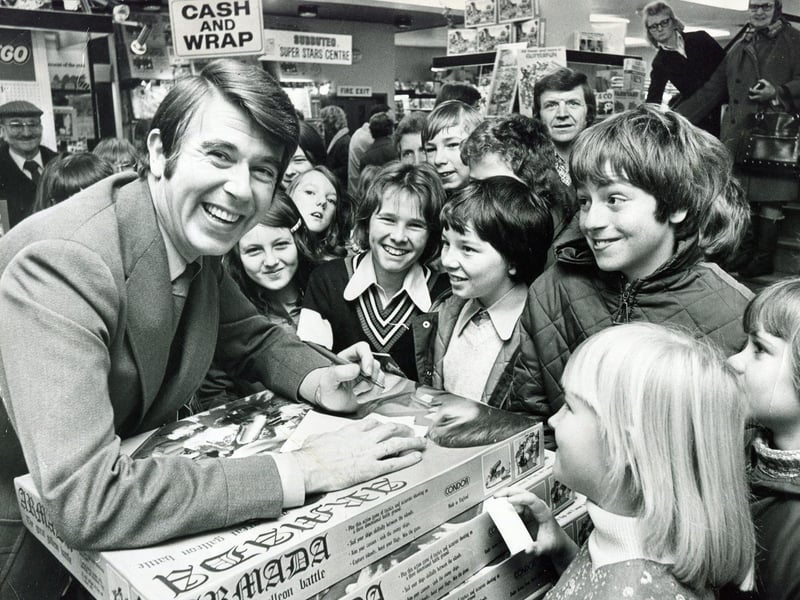 Children's TV star Leslie Crowther draws a crowd to Redgates toy shop, Sheffield, in November 1975 